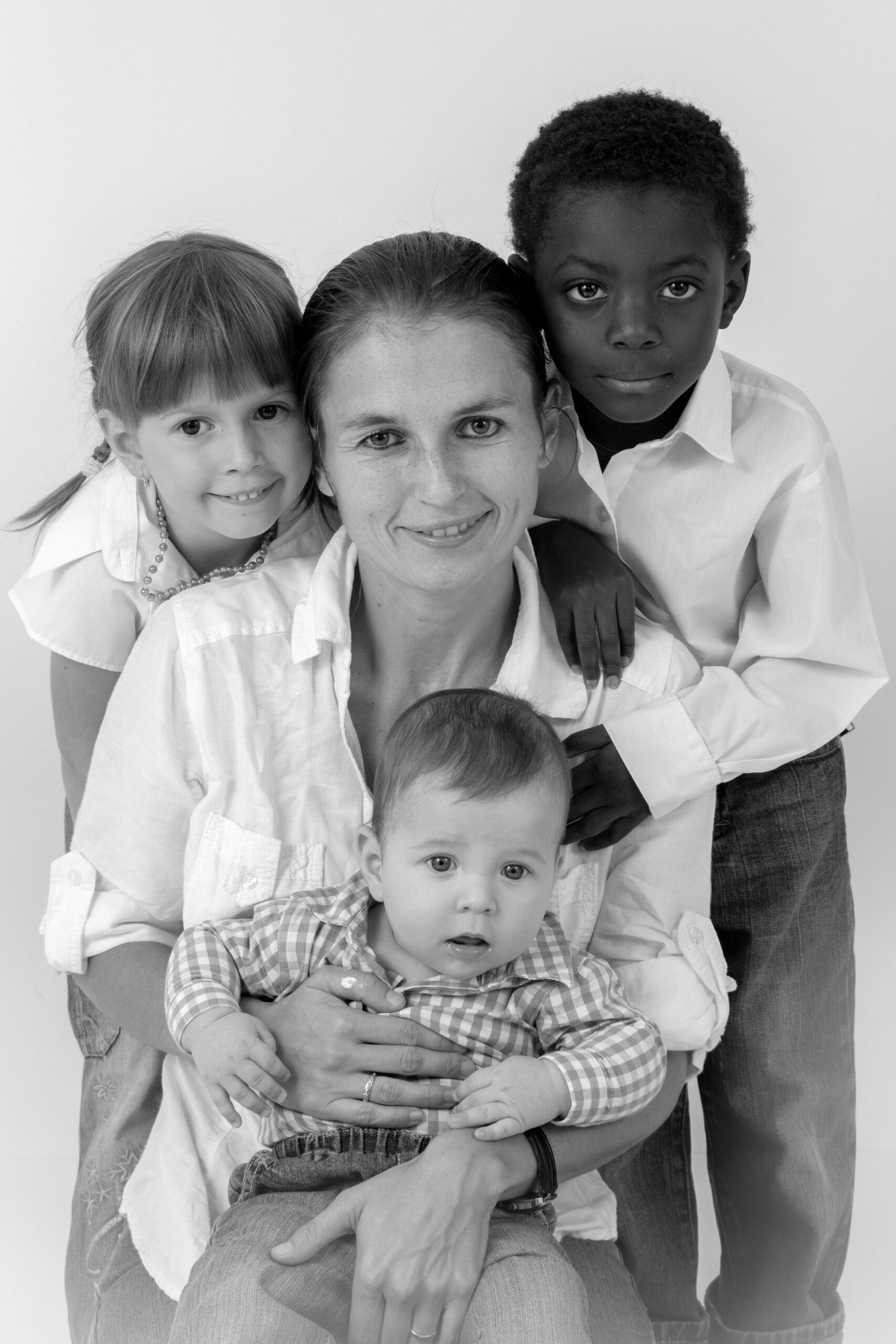 Skupinový portrét rodiny v ateliéru v Kladně – černobílá fotografie matky a tří dětí